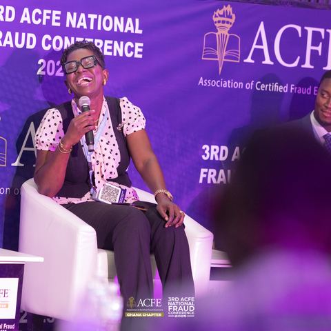 A panelist sharing a laugh during a 2025 session