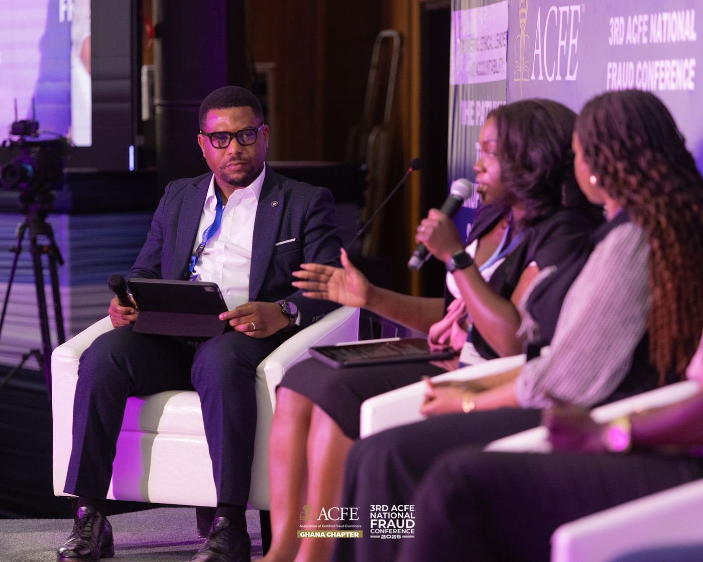 A moderator leading a panel discussion in 2025