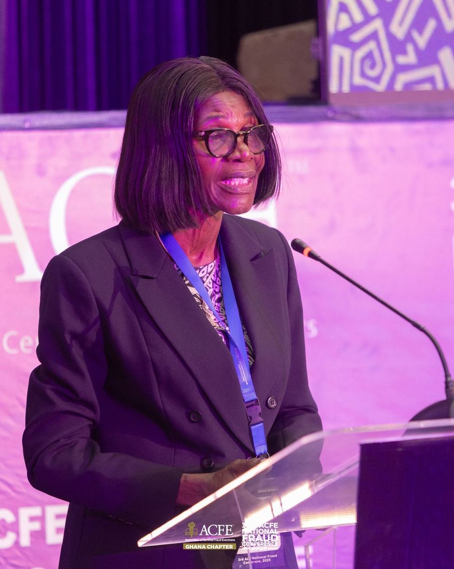 A speaker addressing delegates from the podium in 2025
