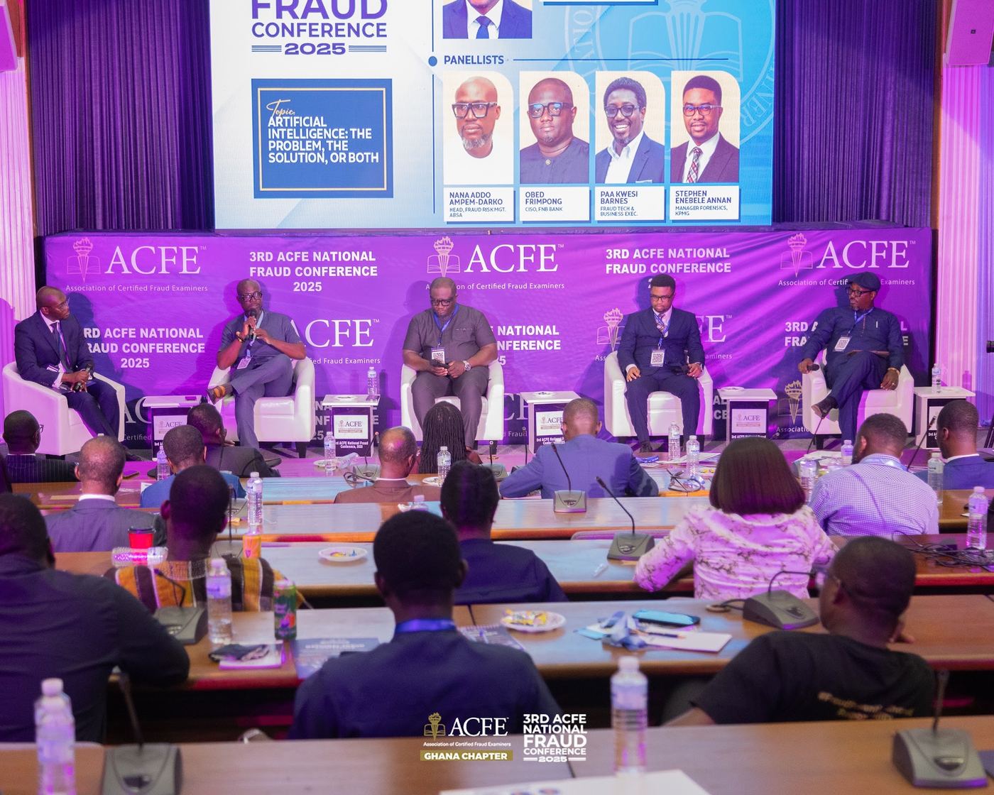 Panelists discussing artificial intelligence and fraud in front of a full hall in 2025
